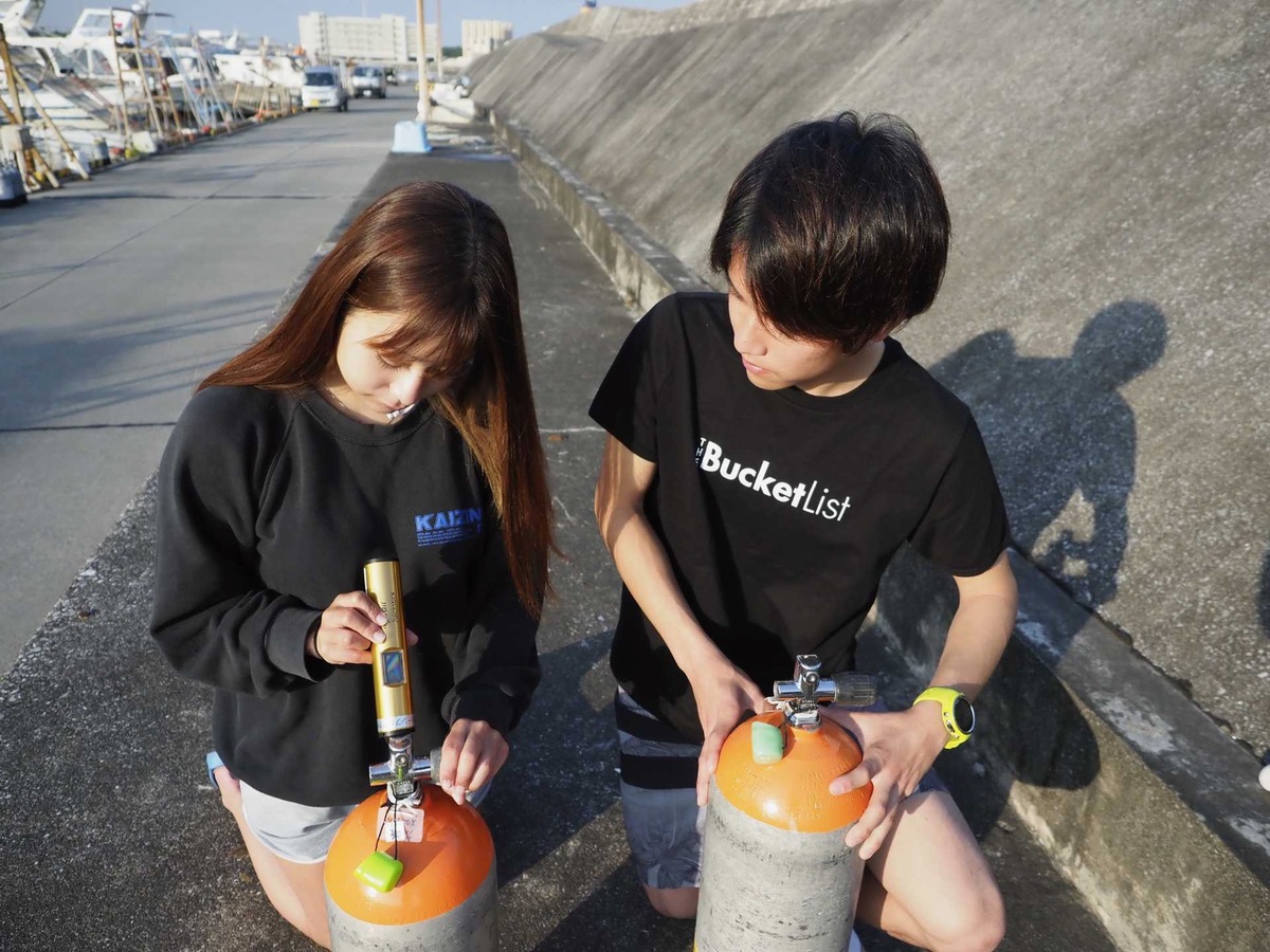 ボンベを持つ男女